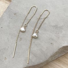 Minimalist Pearl Ear threader earrings, these dainty chain earrings with the perfect touch of femininity and it's great to combine with other earrings or wear alone for a minimalist look.Fun and delicate, these 14k gold-filled threader earrings come with wire bar ends on one side to make it easy to thread the chain through any pierced hole in your ear and on the other side, a small freshwater pearl. Mix and match with other HLcollection earrings for an edgy style statement or wear it on its own Delicate 14k Gold Filled Threader Earrings, 14k Yellow Gold Filled Threader Earrings With Delicate Chain, Delicate 14k Yellow Gold Filled Threader Earrings, Single 14k Gold Filled Threader Earring As Gift, 14k Gold Filled Single Threader Earring Gift, Minimalist Linear Drop Earrings With Delicate Chain, Dainty Long Drop Linear Earrings With Delicate Chain, Dainty 14k Gold Threader Earrings With Adjustable Chain, 14k Gold Filled Long Drop Linear Earrings