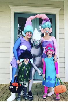 three people in costumes standing on a porch