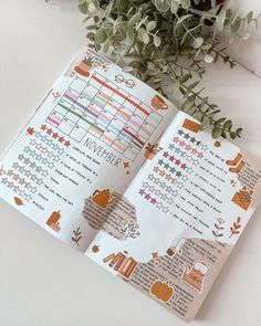 an open planner with stickers on it next to flowers