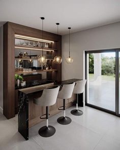 a kitchen with three stools and a bar in front of the sliding glass door