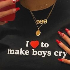 a woman with red nail polish is wearing a t - shirt that says i love to make boys cry