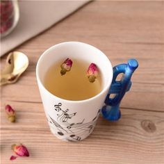 a cup of tea with rose petals in it