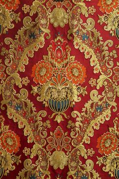 red and gold wallpaper with an ornate design