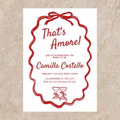 a red and white card with the words that's amore on it, in front of a marble background