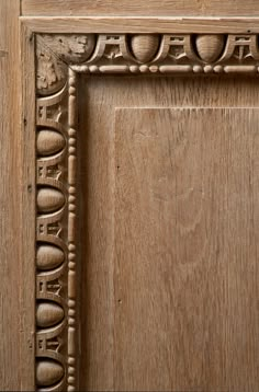 an old wooden door with carvings on the front and side paneled in woodgrain