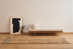 a white couch sitting next to a wooden table on top of a hard wood floor