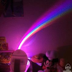 there is a rainbow light coming out of the top of a hat on a desk