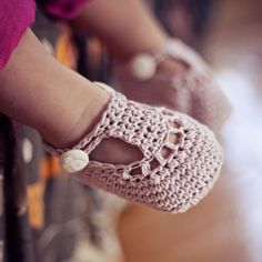 a close up of a person wearing crocheted shoes