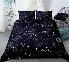 a bed with black and white stars on it in a room next to a chair