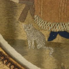 a close up of a painting with animals on it's fabric and gold frame