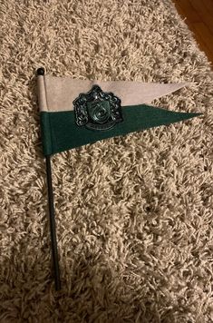 a green and white flag laying on top of a rug