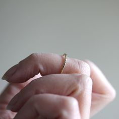 This delicate and luxurious solid 14k or sterling silver simple stacking ring is an absolute classic favorite. The design is clean and simple, and the texture adds a little boho geometric feel. It can be worn as a simple wedding band, or layered with myriad other rings to create a beautiful stack. Made from solid 14k yellow gold or sterling silver twisted wire, formed, soldered and then hammered. The width of the band is just over 1mm. The stack image shows the Simple Twist on the bottom, along Delicate Everyday Stackable Round Band Rings, Dainty Open Band Stackable Promise Rings, Dainty Everyday Stackable Open Band Rings, Dainty Everyday Stackable Rings With Open Band, Dainty Everyday Stackable Toe Rings, Dainty 14k Gold Midi Rings With Diamond Cut, Dainty Hypoallergenic Stackable Wedding Rings, Elegant Hammered Midi Rings For Wedding, Dainty Hypoallergenic Stackable Rings For Wedding