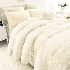 there is a bed with white fur on it