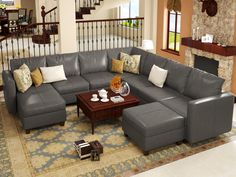 a living room filled with furniture and a fire place next to a stair case in front of a fireplace