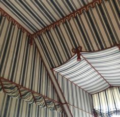 the inside of a striped tent with curtains