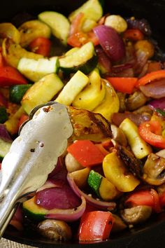 a pan filled with vegetables and a spoon