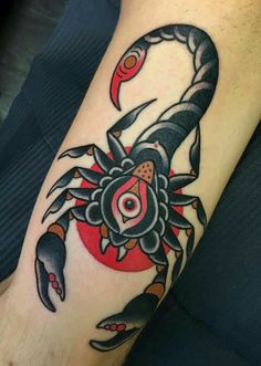 a tattoo on the arm of a man with a crab and sun in it's center