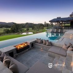 an outdoor fire pit next to a swimming pool