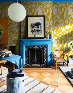 a living room filled with furniture and a fire place in front of a painting on the wall