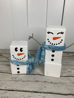 two snowmen made out of toilet paper sitting next to each other