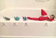 an elf is laying in the bathtub with five different toys