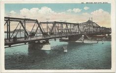 an old photo of a bridge over water