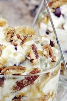 two desserts in glass dishes with spoons on the side