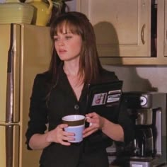 a woman holding a coffee cup in her hands