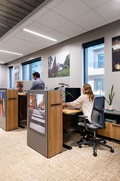 an office with two people sitting at desks