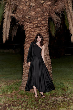 Introducing the Denbury Maxi Dress in Black, a sophisticated event wear piece crafted from bonded fabric. The dress features a bodice with an asymmetrical finish and shoulder panel, creating a modern and elegant silhouette. The sunray pleated skirt cascades gracefully with an irregular hem, adding texture and movement.