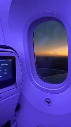 the view from inside an airplane window at sunset or sunrise, looking out into the distance