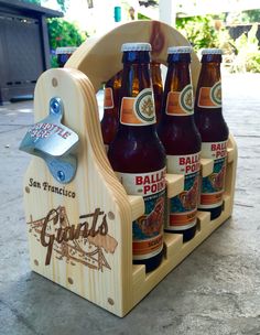 six bottles of beer in a wooden holder