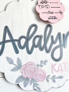 a wooden sign that says aldalyn with flowers on it and the name kate