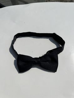 Up for sale is a vintage black pre-tied adjustable bowtie. Perfect for black tie.  The tie is in good used condition, and there is no obvious damage.  Please contact me with any questions!