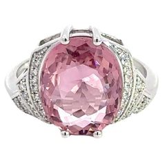 Ring (Matching Earrings Available) 18K White Gold  Weight 4,75 GMS Tourmaline -1/4.86 Cts   Diamond-38/0.129 Cts Size-52 Step back in time with this exquisite Art Deco-inspired ring, elegantly fashioned from 4.75 grams of 18k white gold. This refined piece features a central 4.86-carat pink tourmaline, radiating with vibrant hues that capture the spirit of the roaring twenties. Surrounding this stunning gem are 38 round diamonds, totaling 0.129 carats, that add a sparkling brilliance to the piece. Sized at 52, this ring combines vintage charm with a touch of modern luxury, making it a perfect addition to any sophisticated jewelry collection. With a heritage of ancient fine Swiss jewelry traditions, NATKINA is a Geneva based jewellery brand, which creates modern jewellery masterpieces suita Luxury Tourmaline White Gold Jewelry, The Roaring Twenties, Sophisticated Jewelry, Ring Matching, Eye Makeup Designs, Pink Sparkle, Roaring Twenties, Makeup Designs, Step Back