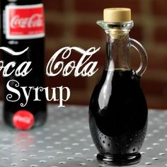 a bottle of coca - cola syrup sitting on top of a table