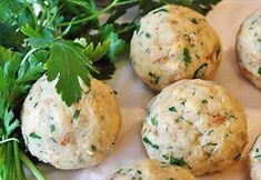 some food that is laying out on a table with parsley and other items around it