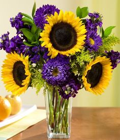 a vase filled with purple and yellow flowers