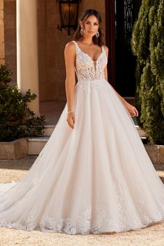 a woman in a wedding dress standing outside