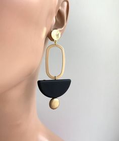 Big Bold Statement Earrings, Minimalist style earrings, Matte Gold EarringsUltra modern earrings, clean cut design to complement any outfit. Very Light weight.Materials: Gold plated brass, Rubberized acrylic bead.Size: Style A 2.6" long, Style B 3" longYour purchase comes in a beautiful box that is ready to give as a gift or to keep for yourself.**Want a custom design?  Just ask! The custom made jewelry is sure to make the owner feel like a super star.  We love mixing finishes. **Please be sure Matte Gold Earrings, Teardrop Pearl Earrings, Geo Design, Moon Necklace Silver, Fan Earrings, Earrings Geometric, Ultra Modern, Triangle Earrings, Earrings Minimalist