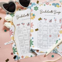 two bachelor party games on a pink table with sunglasses and flowers next to each other