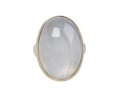 Shimmering with a milky white landscape of subtle iridescence, this Jamie Joseph ring exudes a quiet, elegant beauty. The large oval stone is framed by a band of 14K yellow gold. It is centered on Jamie's signature sterling silver groovy band to create a ring with a cool, casual vibe. Moonstone is known for its gorgeous pearly luster and is believed to release tension, balance emotions and bring light to ones life. white rainbow moonstone : 27mm x 18mmsterling silver groovy band width : 5mm size Elegant Yellow Gold Moonstone Ring With Large Stone, Modern Oval Cabochon Moonstone Ring, Formal Oval Cabochon Moonstone Ring, Modern Oval Moonstone Ring With Large Stone, Timeless Oval Moonstone Ring For Formal Occasions, Large Oval Moonstone Ring, Classic White Oval Moonstone Ring, Oval Cabochon Moonstone Ring In Fine Jewelry Style, Modern Yellow Gold Oval Moonstone Ring