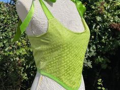 Lime green textured brocade top corset style shape with adjustable shoulder straps and back tied with ribbons.  Made to order. More colours available in our shop. Every order shipped with us will come with a tracking number.  This stunning corset style top has polyester boning to give the front structure and lined with a beautiful soft green satin.  -see our size chart to help assist in selecting a size and measurements or message us.   -Not a hard structured corset.  Made and shipped from our s Spring Party Underbust Bodice, Green Corset Dress With Boned Bodice, Spring Green Corset Dress With Fitted Bodice, Summer Fitted Corset With Tie Straps, Green Corset Back Dress For Party, Green Sleeveless Corset Dress With Boned Bodice, Summer Festival Corset With Boned Bodice, Green Strapless Summer Corset, Fitted Green Corset For Spring