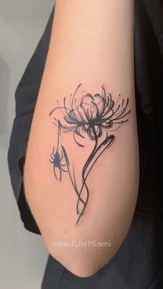 a woman's arm with a flower tattoo on the left side of her body