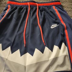 Nike Dri-Fit Dna Basketball Shorts In Navy Blue With A Shark Theme. This Is A Retro From Nikes Original Shark Basketball Release. Made With High-Performance Fabric, These Shorts Are Perfect For Basketball Or Any Occasion. The Size Is A Men's Large. One Side Has A Zipper Pocket, And The Other Pocket Is A Regular Navy Short Sportswear Bottoms, Navy Sportswear Bottoms Short Length, Casual Navy Nike Athletic Shorts, Sporty Blue Short Pants, Nike Blue Sportswear Shorts, Nike Original, Nike Pro Combat, Soccer Shorts, Shorts Nike