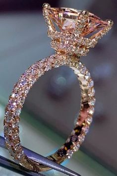 a close up of a diamond ring on top of a table