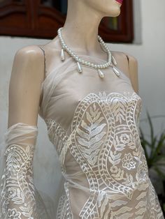 a mannequin wearing gloves and a dress