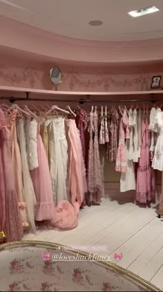 a room filled with lots of pink and white dresses