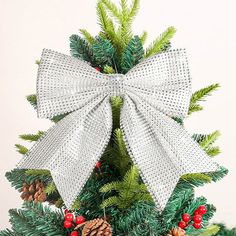 a small christmas tree decorated with pine cones and bows