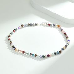 Add a splash of color to your day with our Adjustable Multicolored Pearl Necklace. This piece features nearly round pearls in a spectrum of colors, strung together with an adjustable extension chain. It's a versatile and vibrant accessory that can adapt to any neckline or outfit. Length: 18" inches with an extension chain of 2" inches, perfect for women. (45cm - 51cm) Product Information Pearl Type Freshwater Origin China Shape Nearly Round Quality AA+ Size 6-7mm Nacre Very Thick Color Colored M Multicolor Beaded Necklace With Pearl Charm, Multicolor Single Strand Round Pearl Necklace, Elegant Multicolor Single Strand Pearl Necklace, Elegant Multicolor Pearl Necklace With Charm, Multicolor Polished Pearl Beads Necklace, Multicolor Pearl Necklace With Polished Beads, Multicolor Polished Pearl Bead Necklace, Rainbow Pearl Necklace With Round Beads, Multicolor Round Beads Pearl Necklace